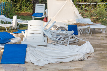 Straw loungers and sun loungers at the water park after  tornado.