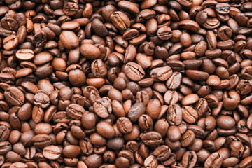 Coffee beans background. Brown roasted coffee beans. Many coffee beans. Coffee beans can be used as a background. Fresh roasted coffee beans.