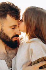 Cute little daughter in his fathers arms. Dad and daughter having fun on sunny summer day in park....