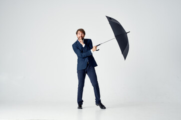 business man in a suit holding an umbrella elegant style rain protection