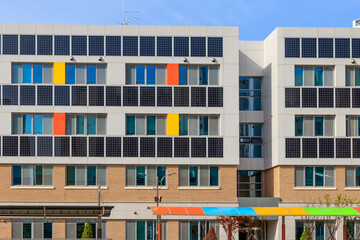 Obraz premium Building solar panels. Solar elementary school building. Eco-friendly school building. Solar panel on the wall of the building.