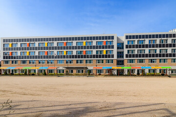 Building solar panels. Solar elementary school building. Eco-friendly school building. Solar panel on the wall of the building.