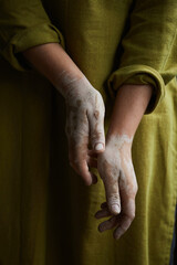 Fototapeta premium Close Up Of Ceramist's Hands Dirty Of Clay. Pottery studio The process of creating pottery. The master ceramist works in her studio