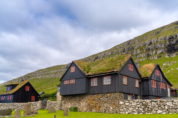 Fototapeta na wymiar The old farmhouse of Kirkjubøargarður still inhabited since the 11th century in Kirkjubøur (Kirkebø) a historical village on Streymoy, Faroe Islands.