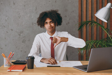 Young sad displeased dissatisfied african american employee business man in classic shirt tie show...