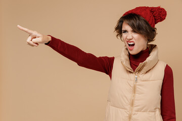 Young angry furious agressive caucasian woman 20s wears red turtleneck vest beret point index...