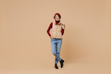 Full body young woman 20s wears red turtleneck vest beret hold takeaway delivery craft paper brown...