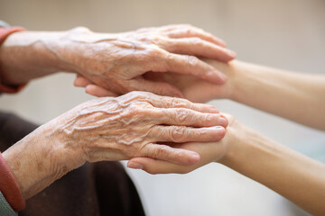 The hands of the child in the hands of the grandmother, the old brownish skin in the elderly woman,...