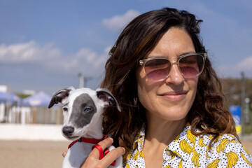 Cute pet whippet puppy with female owner