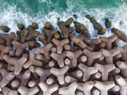 Top view shot of tetrapods at the edge of the sea