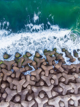 Top view shot of tetrapods at the edge of the sea