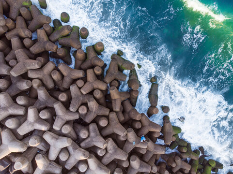 Top view shot of tetrapods at the edge of the sea