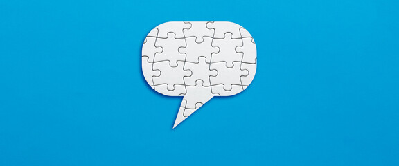 Speech balloon made out of puzzle pieces. Puzzling or ambiguous message in communication or...