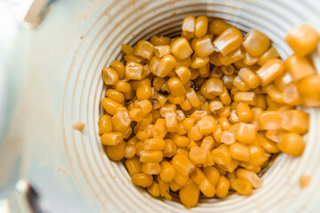  Lots of canned corn in an aluminum can. Close-up top view. High quality photo