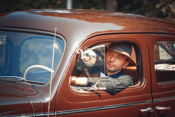 Young man in retro car