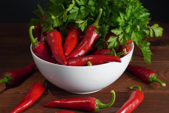 Red chili peppers and parsley in white plate
