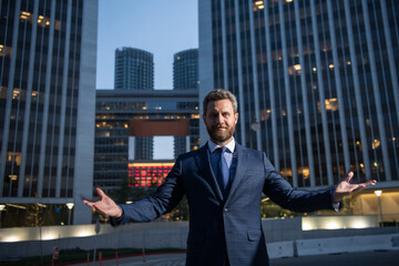 Portrait of businessman in front of modern office.