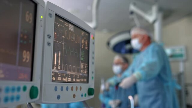 Monitors in intensive care unit. Heart beat of a patient on the screen of computers during operation in the hospital. Healthcare concept.