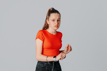 Brunette teen girl with disgusted expression repulsing something. Disgust concept. Young emotional...