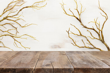 Halloween holiday concept. Empty rustic table in front of bare trees background. Ready for product...