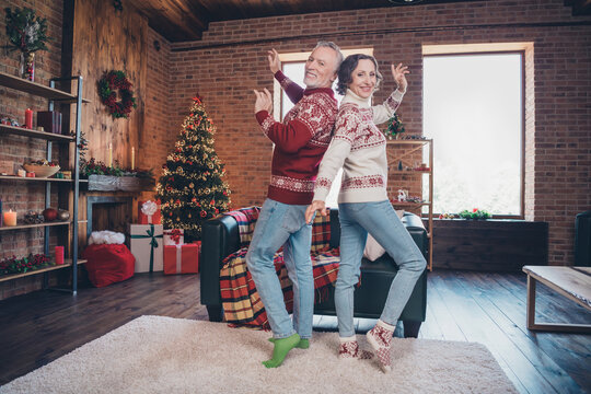 Full length body size photo senior couple dancing together before new year in decorated apartment