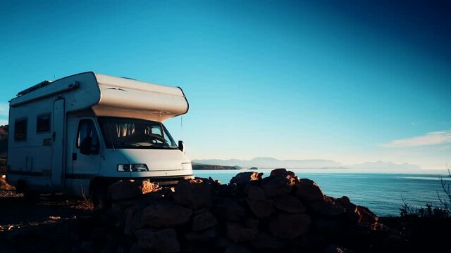 Camper vehicle camping by sea. Tour with motor home. Caravan vacation. Nature and activities.