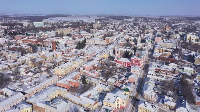 Scenic aerial view of covered with snow houses and churches in Russian city of Yelets on sunny winter day, Lipetsk Oblast