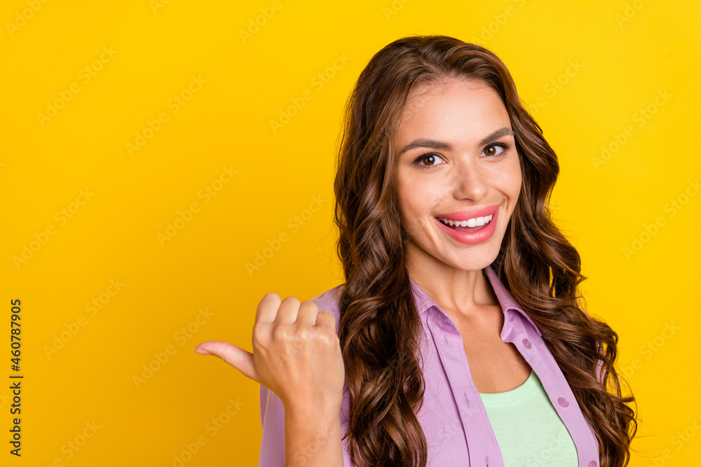 Poster Portrait of attractive cheerful wavy-haired girl demonstrating copy blank place space ad isolated over bright yellow color background