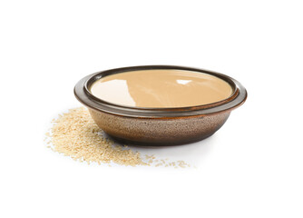 Tasty sesame paste in bowl and seeds on white background