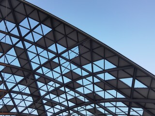 Fototapeta premium A modern building with a curved roof, aluminum and glass.