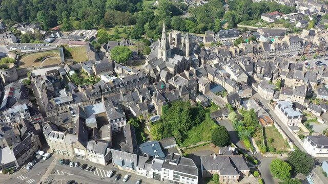 Flight over the city Guingamp and Basilica of Our Lady of Merciful on summer day. France