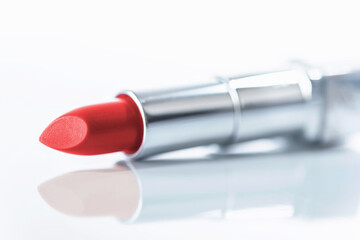A new red lipstick on a white background, close up, isolated