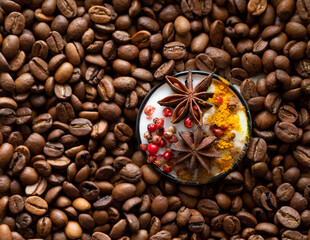 Obraz na płótnie Canvas Cup of coffee with spices among coffee beans