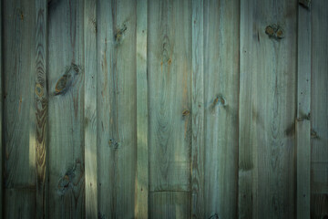 Wooden logs of an old house. Close-up. Weathered green wood texture. Background. Horizontal vertical photo.