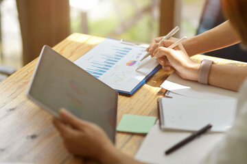 Two senior business entrepreneur working together on tablet and reports