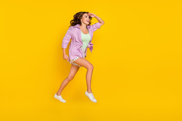 Fototapeta na wymiar Full length photo of positive young woman jump up look empty space dream forward isolated on yellow color background