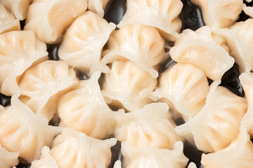 Traditional Asian Prawn or shrimp dumplings hakau, ha kauw or har gow. Served with cabbage, carrot...