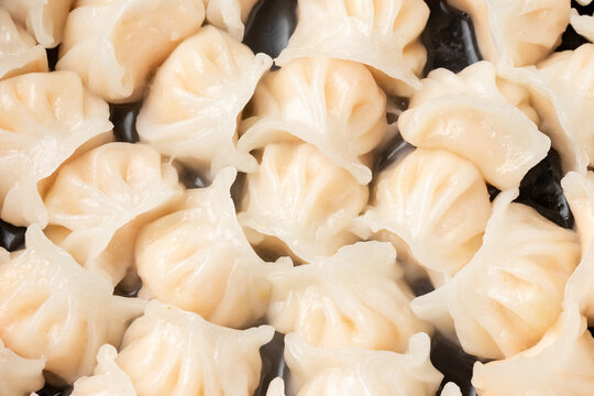 Traditional Asian Prawn or shrimp dumplings hakau, ha kauw or har gow. Served with cabbage, carrot salad and soy and sweet chilli sauce
