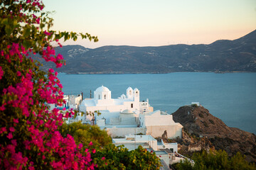 White Greek Church on the island at sunset in sunbeams