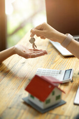 Real estate realtor or broker giving a house keys to new owner