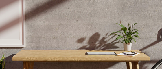 Closeup Modern minimalist workplace with copy space on a wooden table against grey cement wall