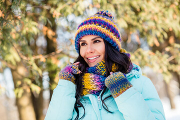 Photo of dreamy inspired lady beaming smile wear knitted mittens headwear scarf coat in park outside