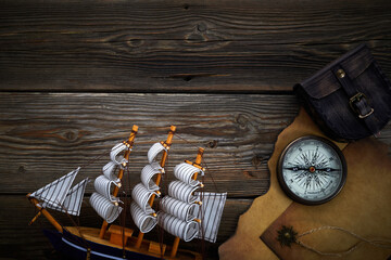 Columbus Day. Vintage discovery equipment with copy space on dark wooden background.