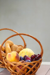 Two baskets full of fresh fruit and vegetable in a garden. Selective focus.