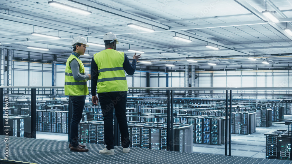 Leinwandbilder korean data center system administrators and african american it specialists in high visibility vest