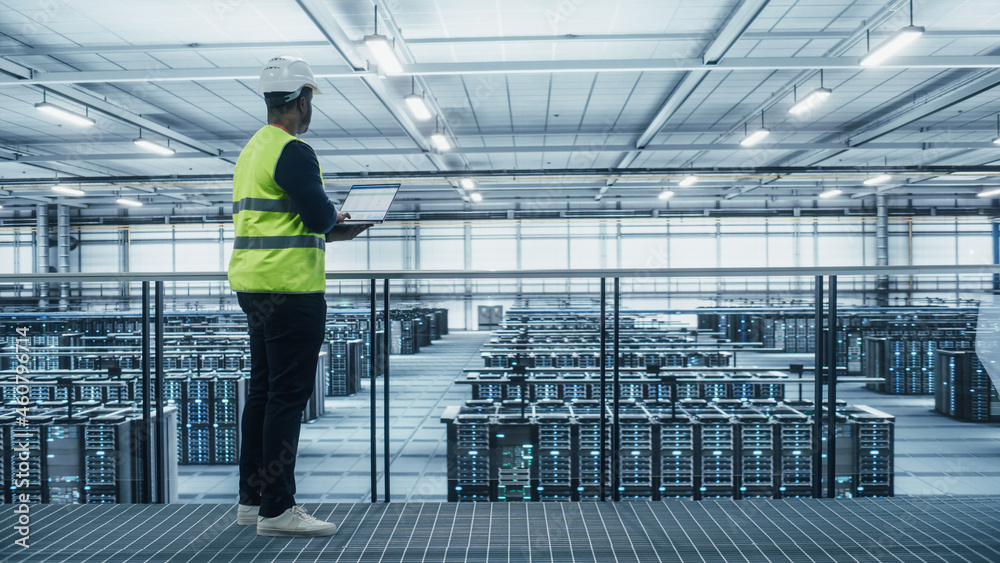Aufkleber Data Center Engineer in High Visibility Vest Using Laptop Computer. Server Farm Cloud Computing Facility with Black Male System Administrator Working with Data Protection Network for Cyber Security.