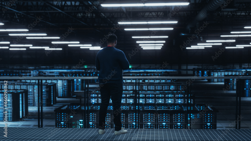 Poster Data Center Engineer Using Laptop Computer. Server Farm Cloud Computing Specialist Facility with African American Male System Administrator Working with Data Protection Network for Cyber Security.