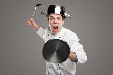 Angry chef with kitchen utensils