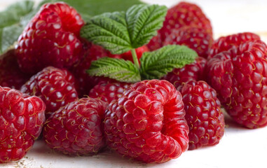 image of raspberries with leaves on a white background