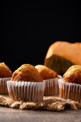 Pumpkin muffins on wooden table	